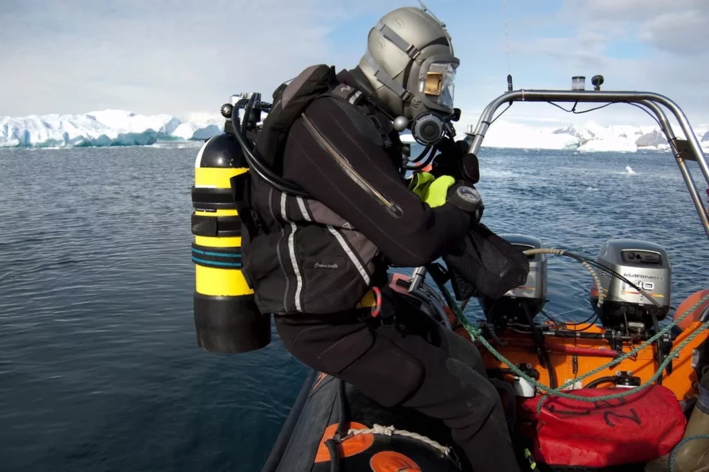 A-diver-about-to-enter-the-water-from-the-support-boat-for-a-dive-around-Rothera-Research-Station.-Melody-Clark-BAS-1024x681