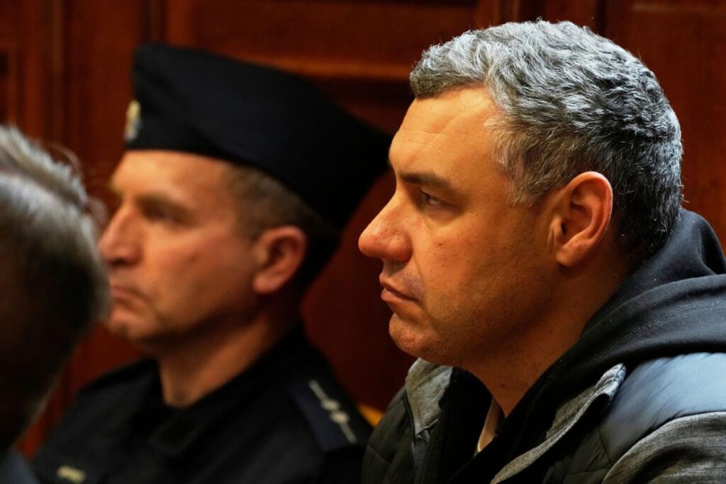 Ukrainian defendant Volodymyr Zhuravlov, right, listens as a judge announces the decision not to allow for extradition to Germany in courtroom of Warsaw's Regional Court in Warsaw, Poland, Friday, Oct. 17, 2025